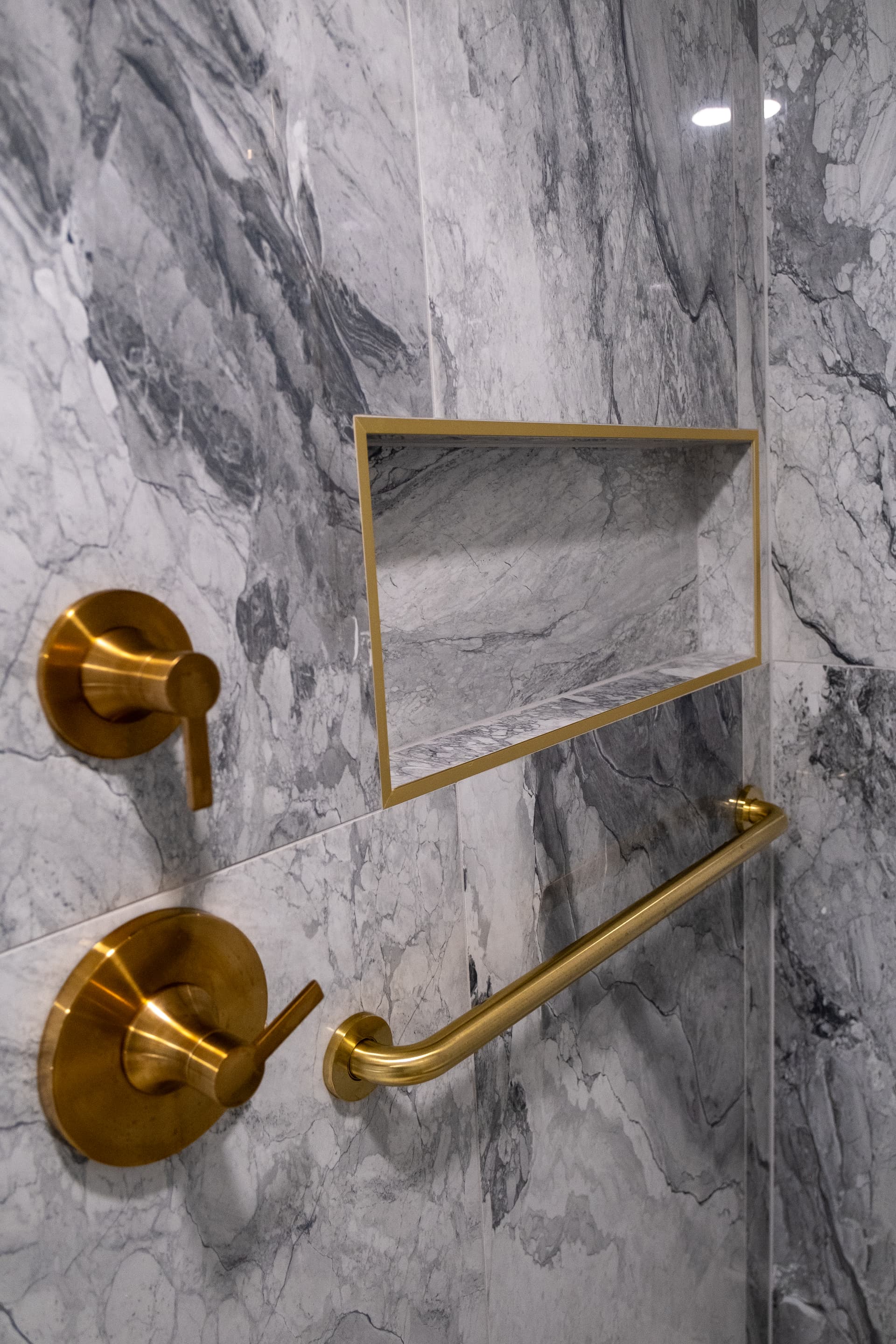 Shower hardware and marble detail