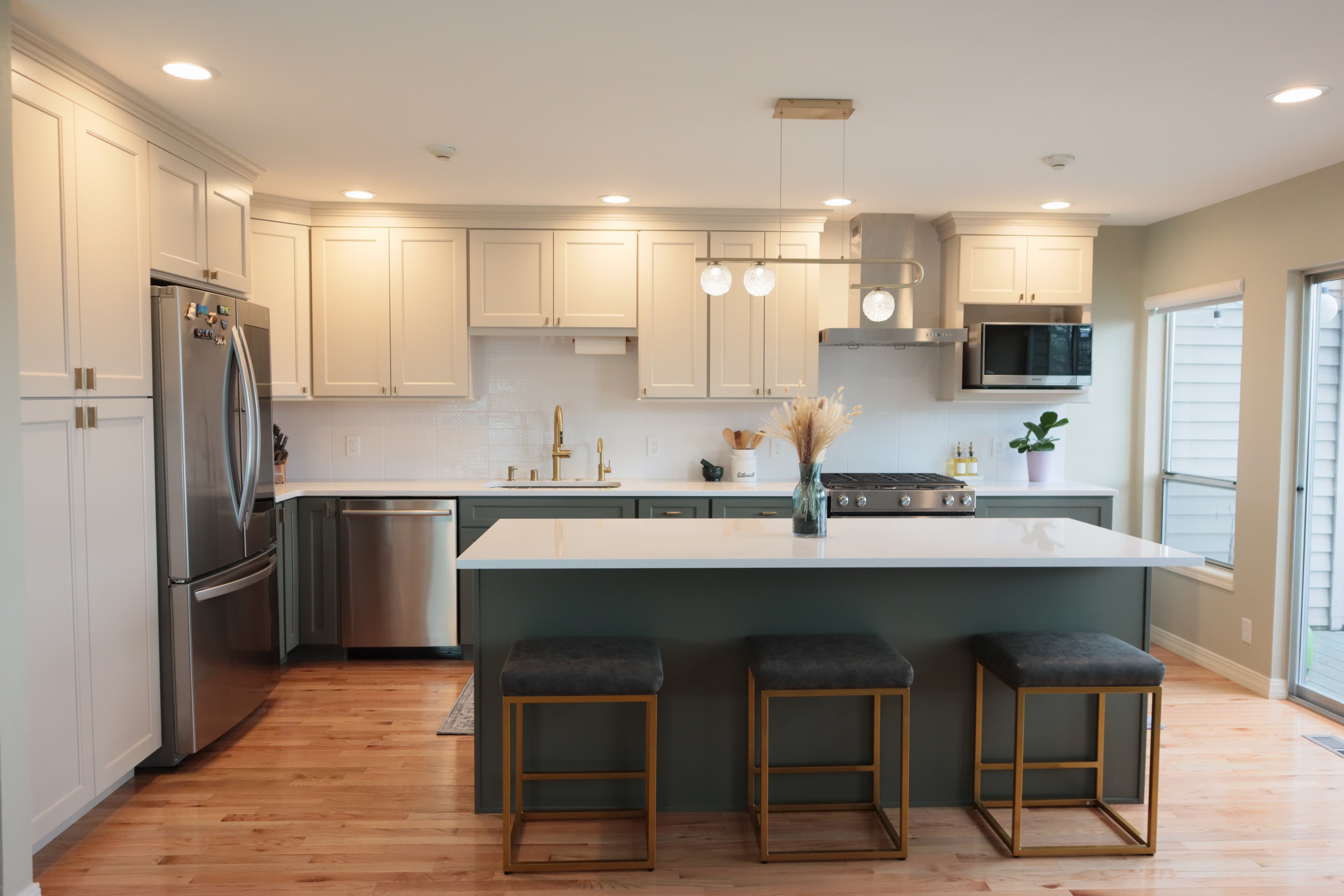 Modern kitchen with teal island and brass accents