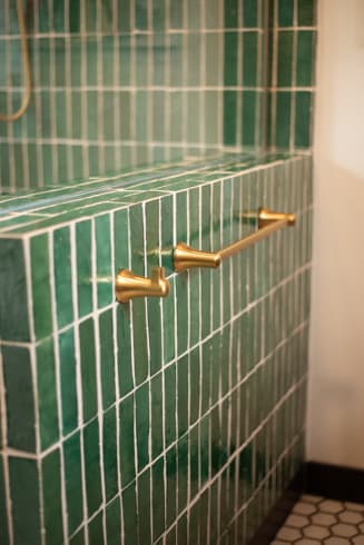 Tiled shower bench with brass grab bar