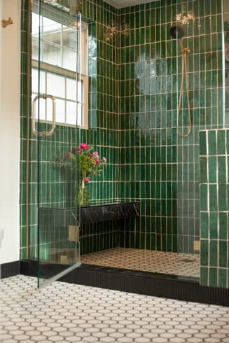 Green tile shower with glass enclosure